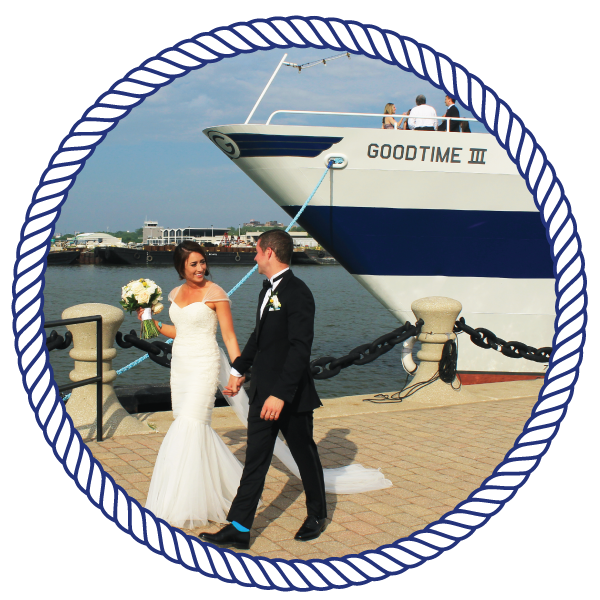 bride and groom, walking down a pier, with the goodtimeiii boat in the background