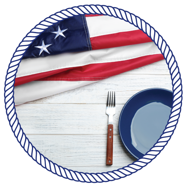 american flag, next to an empty plate with a fork and knife