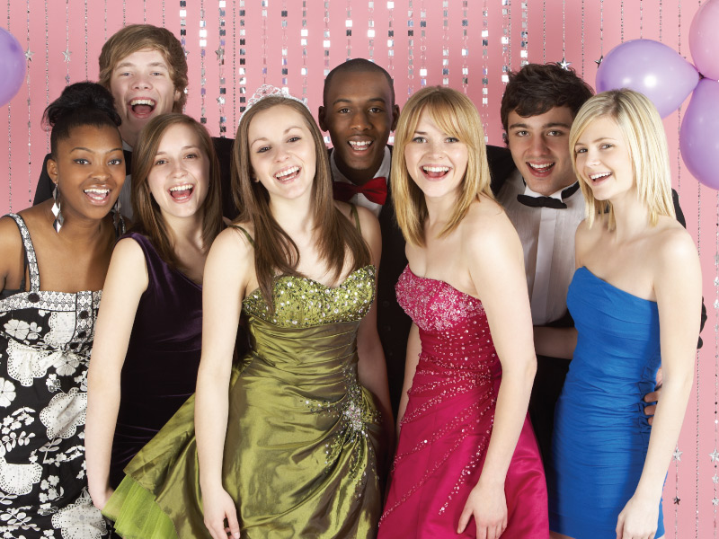 group of teenage students, dressed for prom, smiling towards the camera